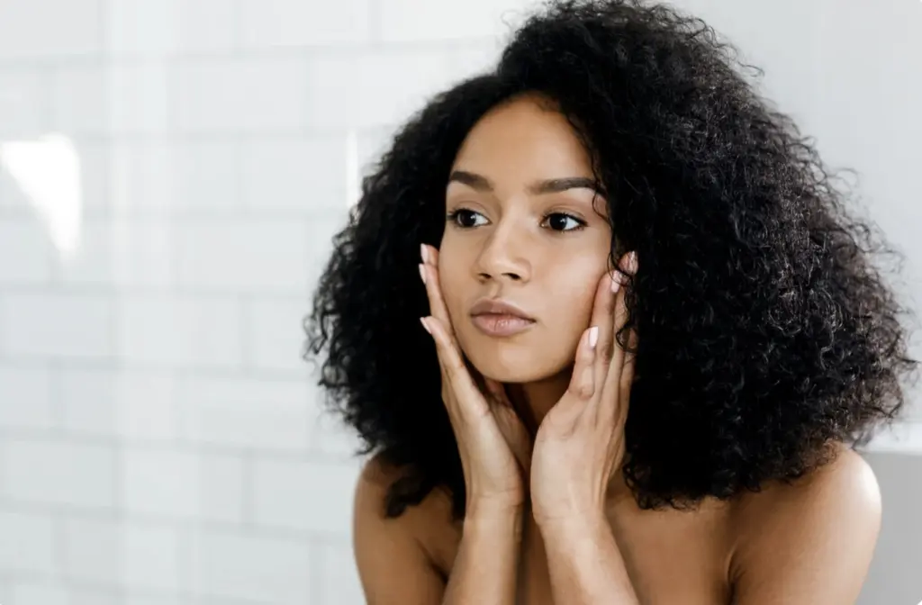 Woman looking at her face